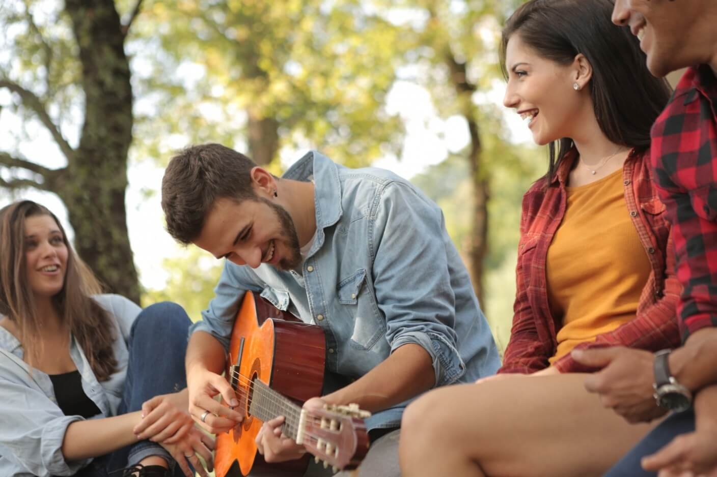 Man playing guitar with friends